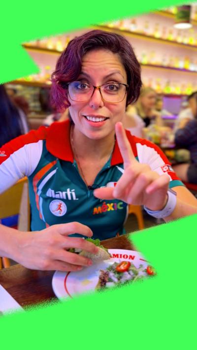 BBC's Laura Garcia smiles to the camera wearing a Mexico jersey.
