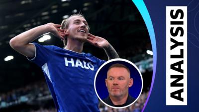 Ipswich's Jack Clarke celebrates by cupping his ears to the crowd, as Wayne Rooney talks on Match of the Day