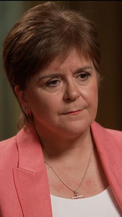 Head and shoulder shot of Nicola Sturgeon. She is wearing a pink blazer and looking to the side.