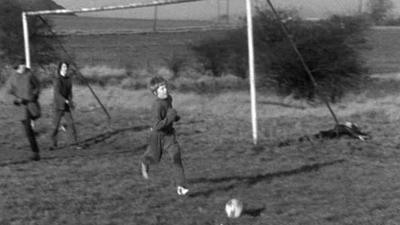 Schoolboy Colin Walker playing football.