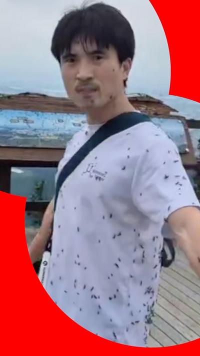 A man covered in flies.
