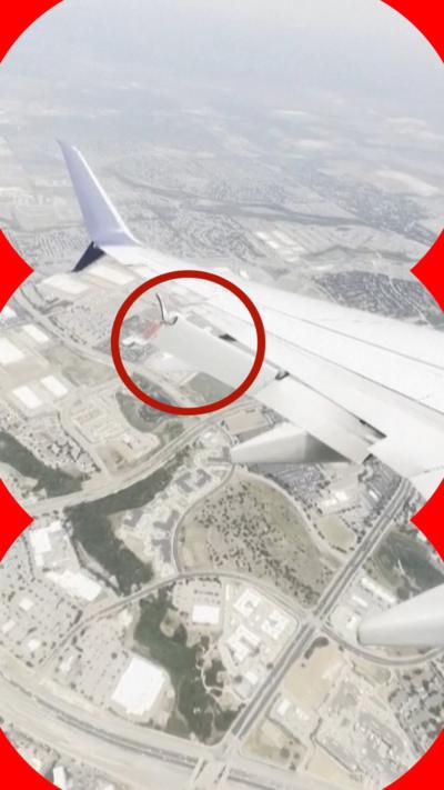Damaged plane wing as viewed from cabin mid-flight 