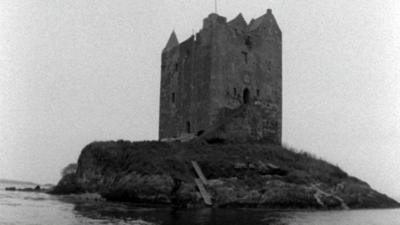 Scottish castle surrounded by a body of water