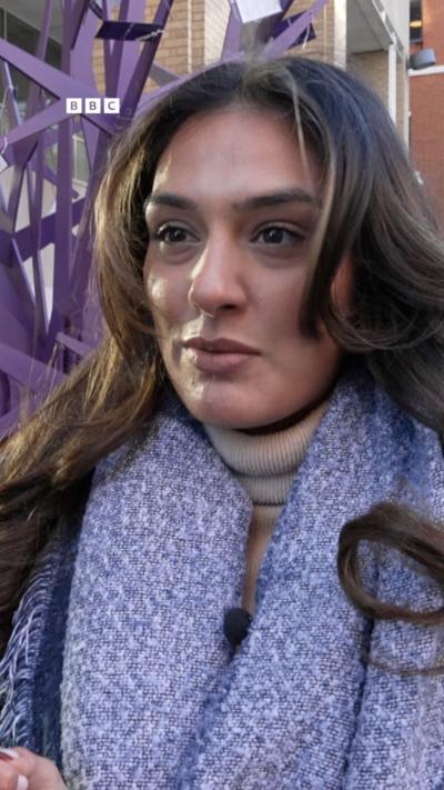 woman in purple scarf with long brown hair