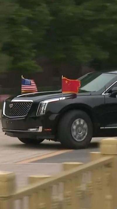 Black car with Chinese and USA flags. 