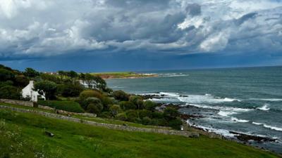 Shower clouds over a coastal village 