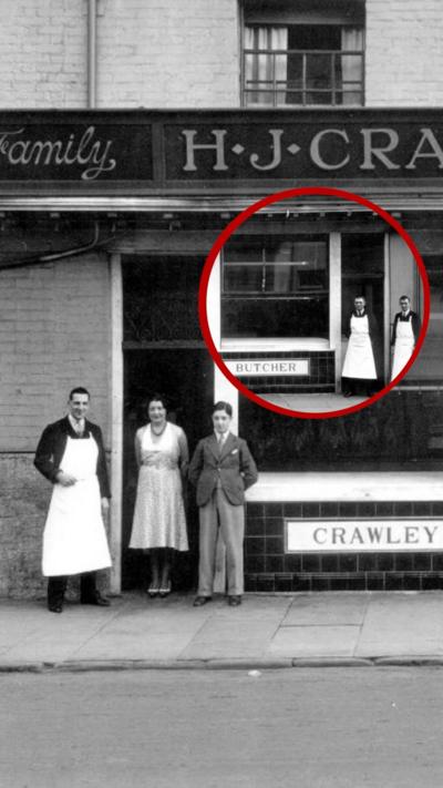black and white photo of a butcher's shop showing three people at the door