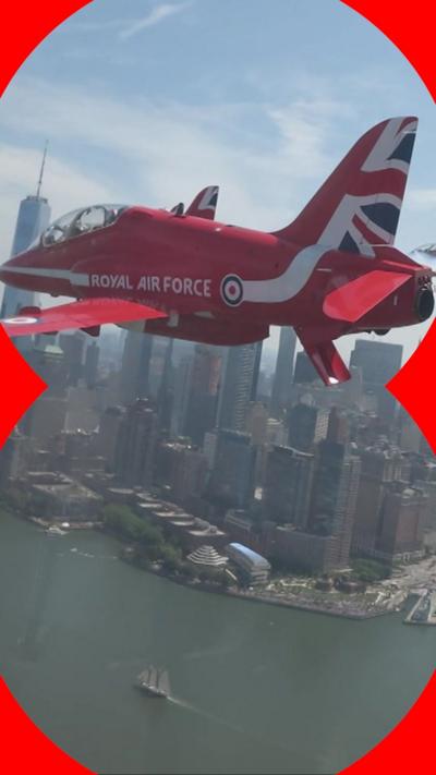 A Red Arrow plane flying over the New York City skyline