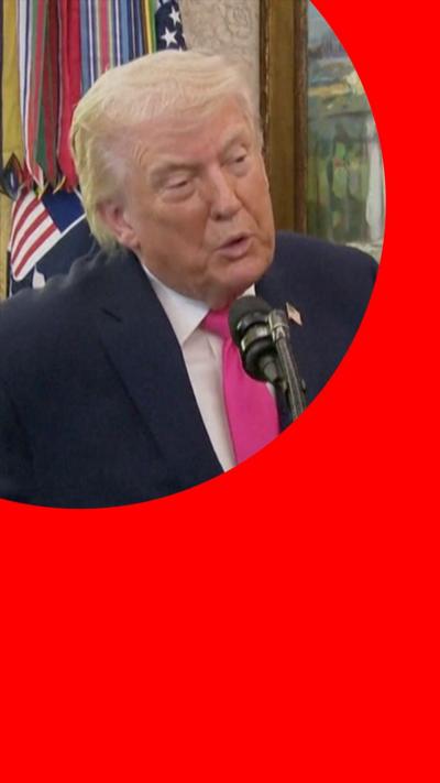 Donald Trump speaking at the White House, wearing a pink tie