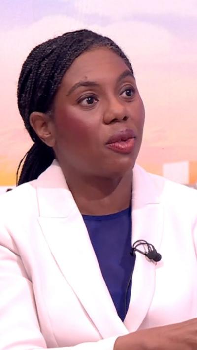 Kemi Badenoch wearing a white suit