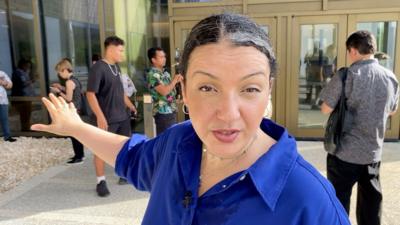 BBC correspondent Shaimaa Khalil stands outside court building in Saipan