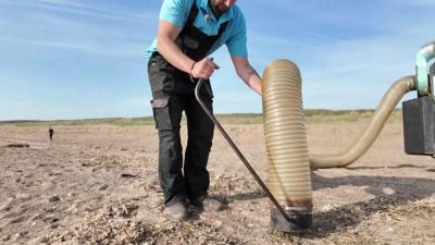 A volunteer has created a nurdle vacuum to clean this beach in Lincolnshire.