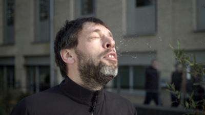 Image of a man sneezing