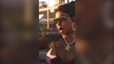 A screen grab grom the GTA trailer showing a woman with tied back hair wearing sunglasses and jewellery