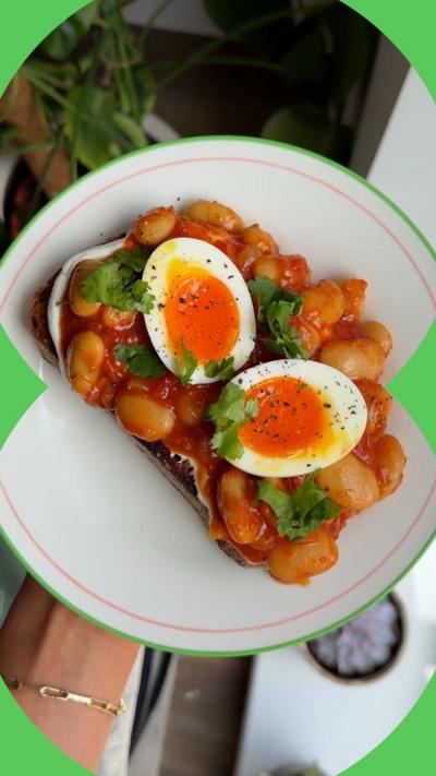 A white plate with eggs and beans on it