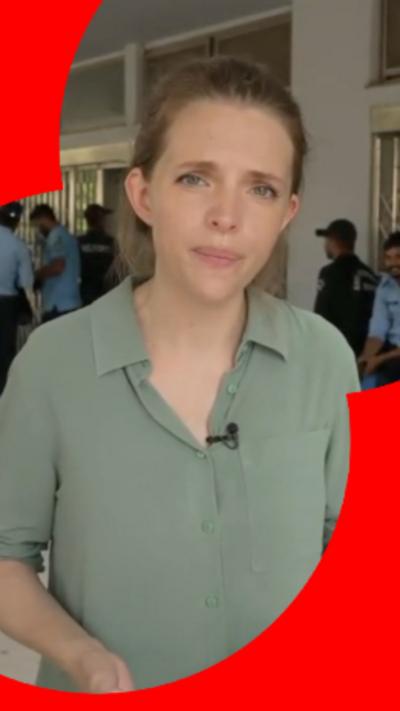 BBC Correspondent Carrie Davies has blonde hair and is wearing a green shirt.