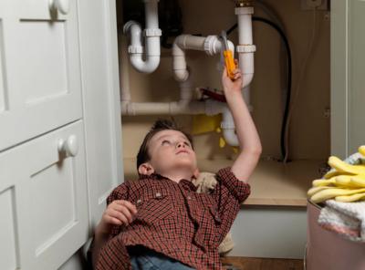 Boy doing plumbing