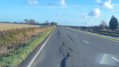 Forty Foot Bank with large cracks in the road