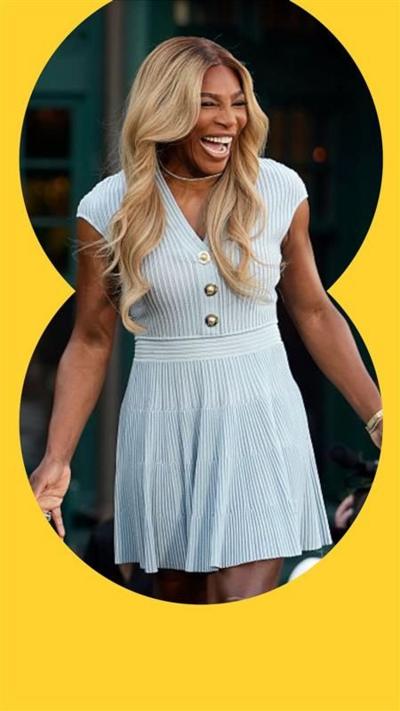 Serena Williams smiles in a light blue dress. She has long wavy blonde hair.