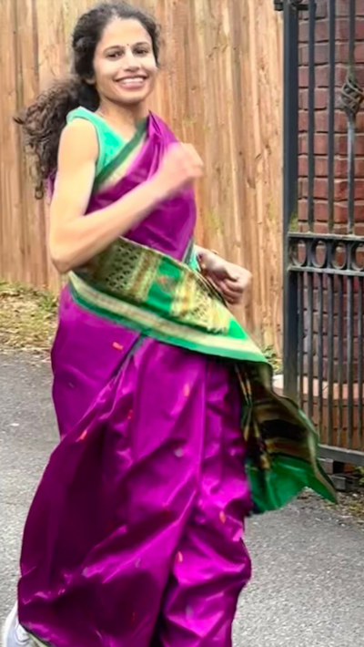 A woman runs in a sari