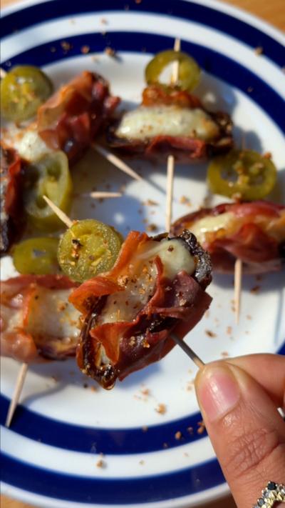 Food on cocktail sticks on a white and blue plate