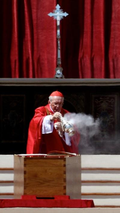 Cardinal Giovanni Battista Re blesses the coffin during the funeral Mass of Pope Francis