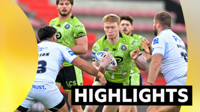 Wigan's Zach Eckersley tackled by Toulouse' Anthony Marion and Rob Butler