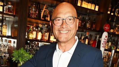 Gregg Wallace smiles in a bar