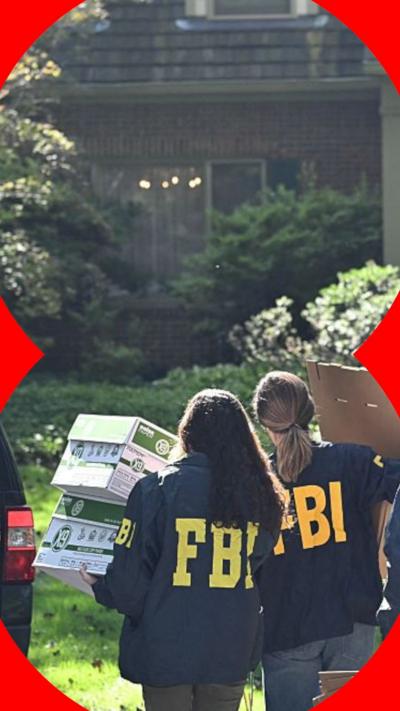 FBI agents carrying boxes