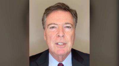 James Comey speaks to the camera.