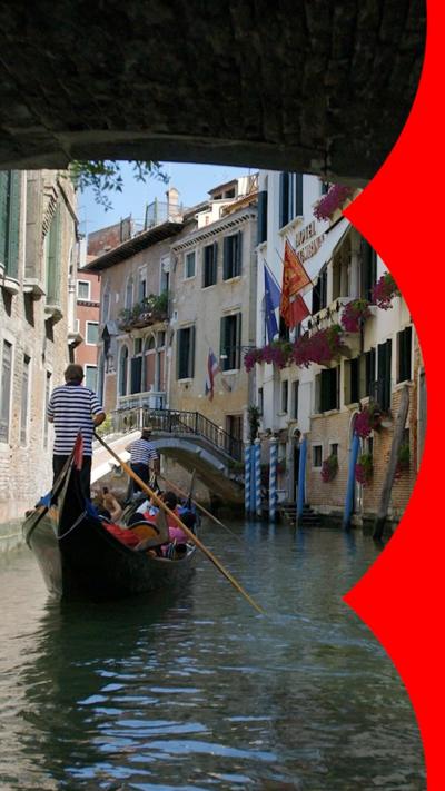 A gondola on a canal in Venice, with buildings either side of the water