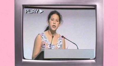 13 year old child speaks at a lectern on an 90s TV screen