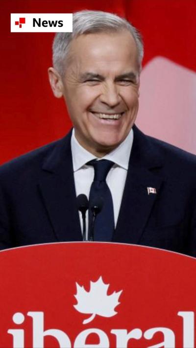 Mark Carney smiling in front of a Canadian flag, next to a podium that reads 'Liberal