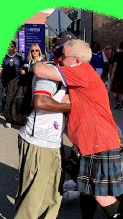 A Scotland and Haiti fan hug