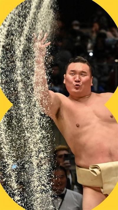 Sumo wrestler throwing sand in the air
