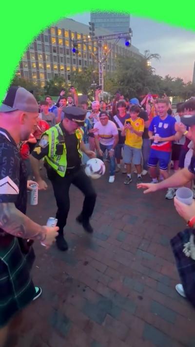 Watch as a Boston police officer entertains football fans with keepy-uppies.