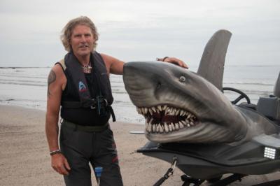 Fin Bowron stood beside his water-worthy creation, the shark boat