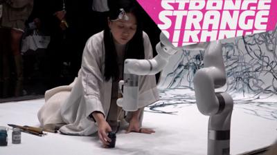 An artist and robot and the Strange News logo