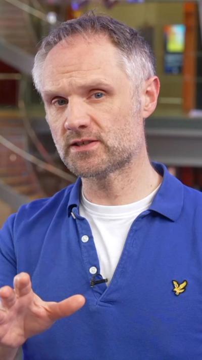 Verify presenter looks into the camera at the BBC office