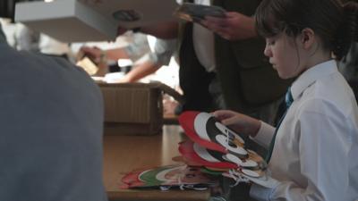 Child packing a box ahead of Christmas