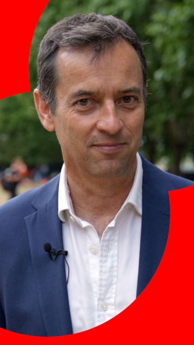 Damian Grammaticas looks into the camera as he stands outside parliament