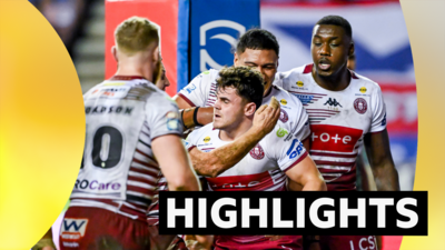 Wigan Warriors players celebrate a try against Leigh