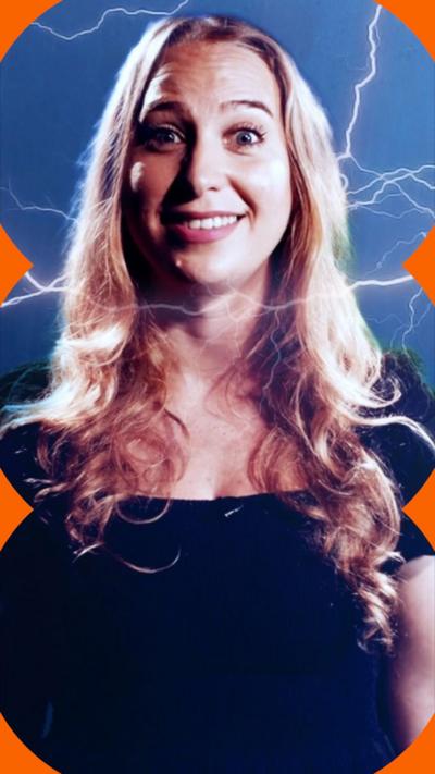 A woman with long blonde hair looks at the camera as lightening created using a green screen surrounds her 