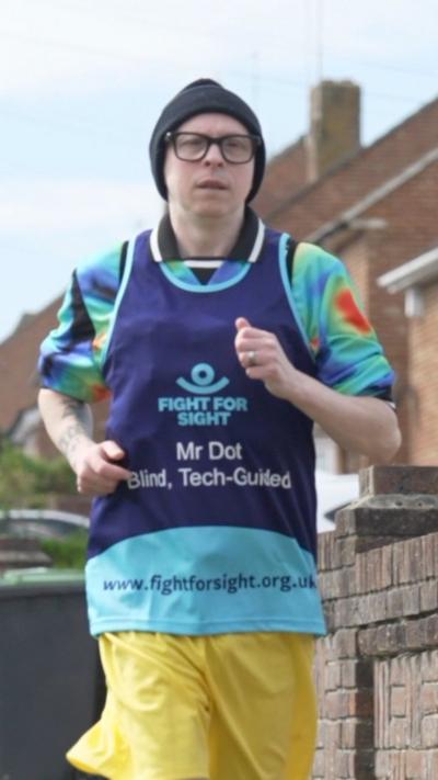 A man in running gear and glasses.