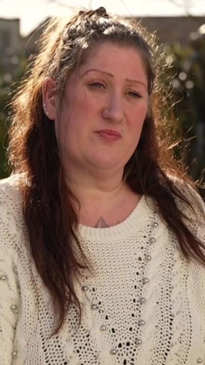 A woman wearing a cream jumper