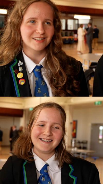 Twins with red hair wearing green blazers, discuss their exam results.