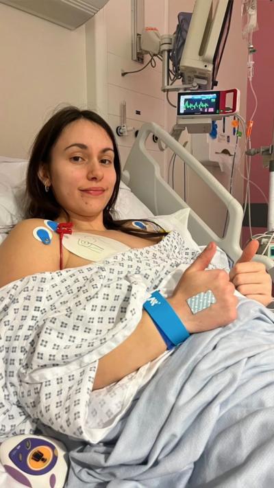 A woman with long dark hair lying in a hospital bed