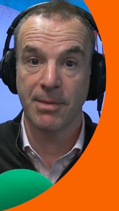Martin Lewis wears headphones 