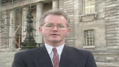 Reporter standing in front of a court 