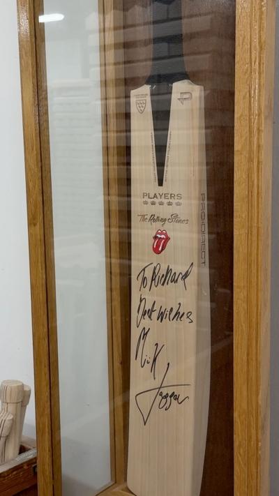 A signed cricket back in a protective display case.